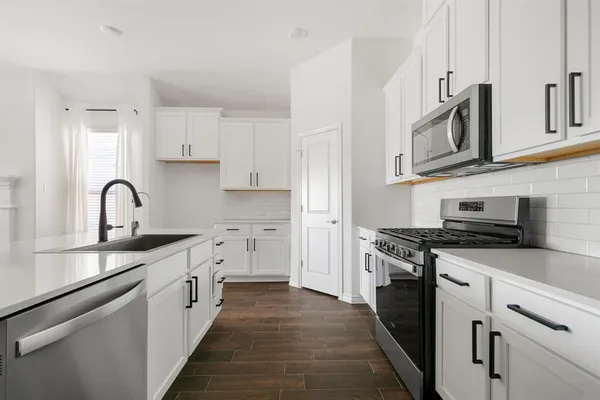 a kitchen with stainless steel appliances granite countertop a stove and a sink