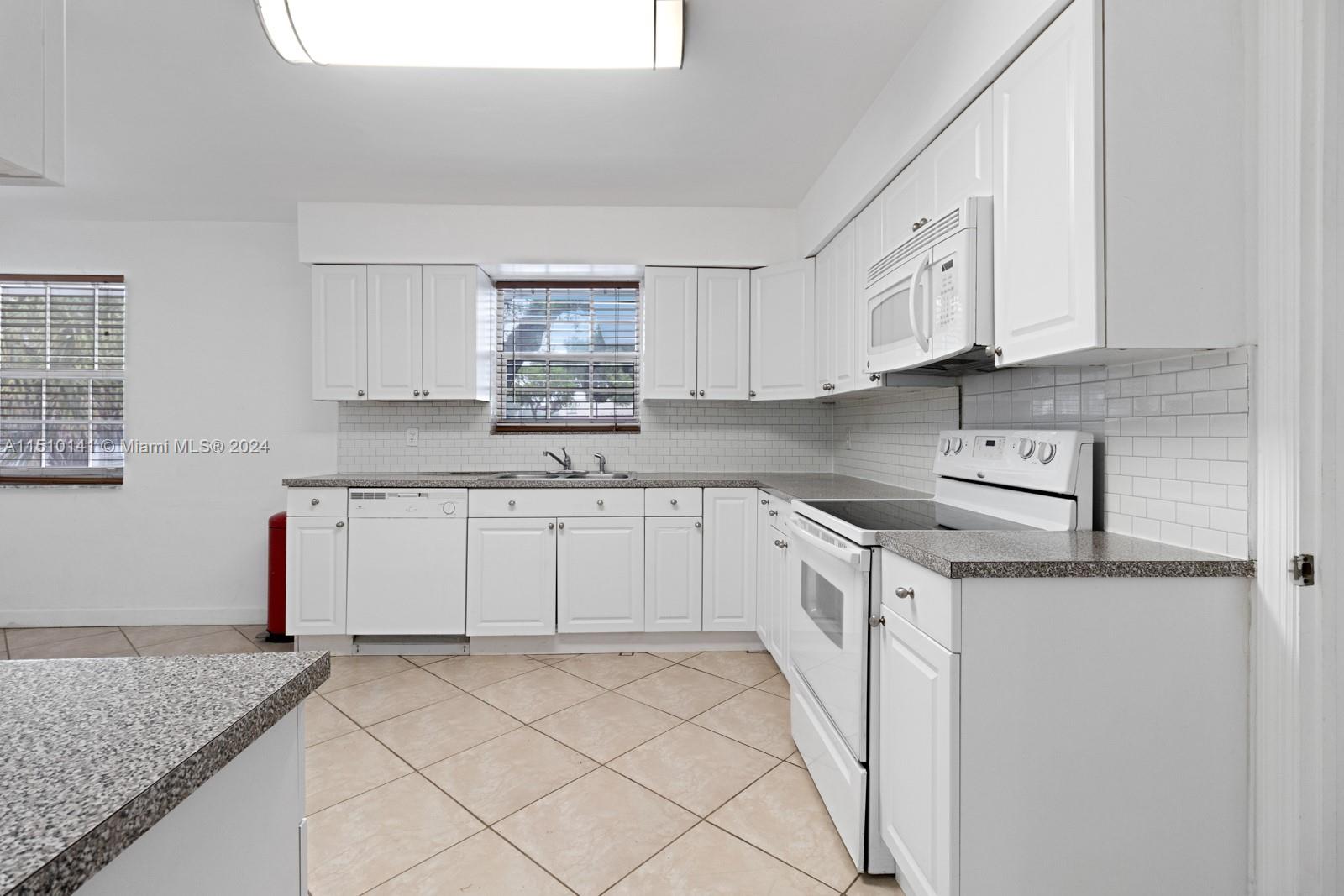 2037 Southwest 22nd Terrace Miami, FL 33145 - Photo 11 of 19 a kitchen with stainless steel appliances granite countertop a sink and cabinets