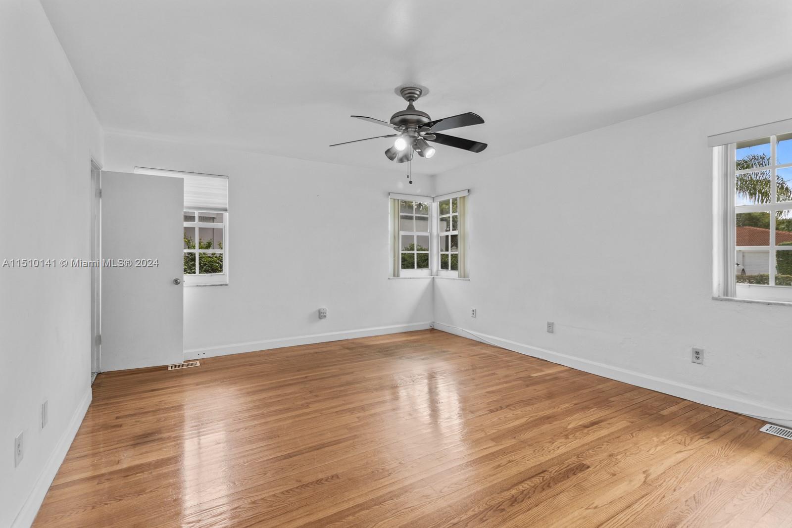 2037 Southwest 22nd Terrace Miami, FL 33145 - Photo 13 of 19 a view of empty room with wooden floor and fan