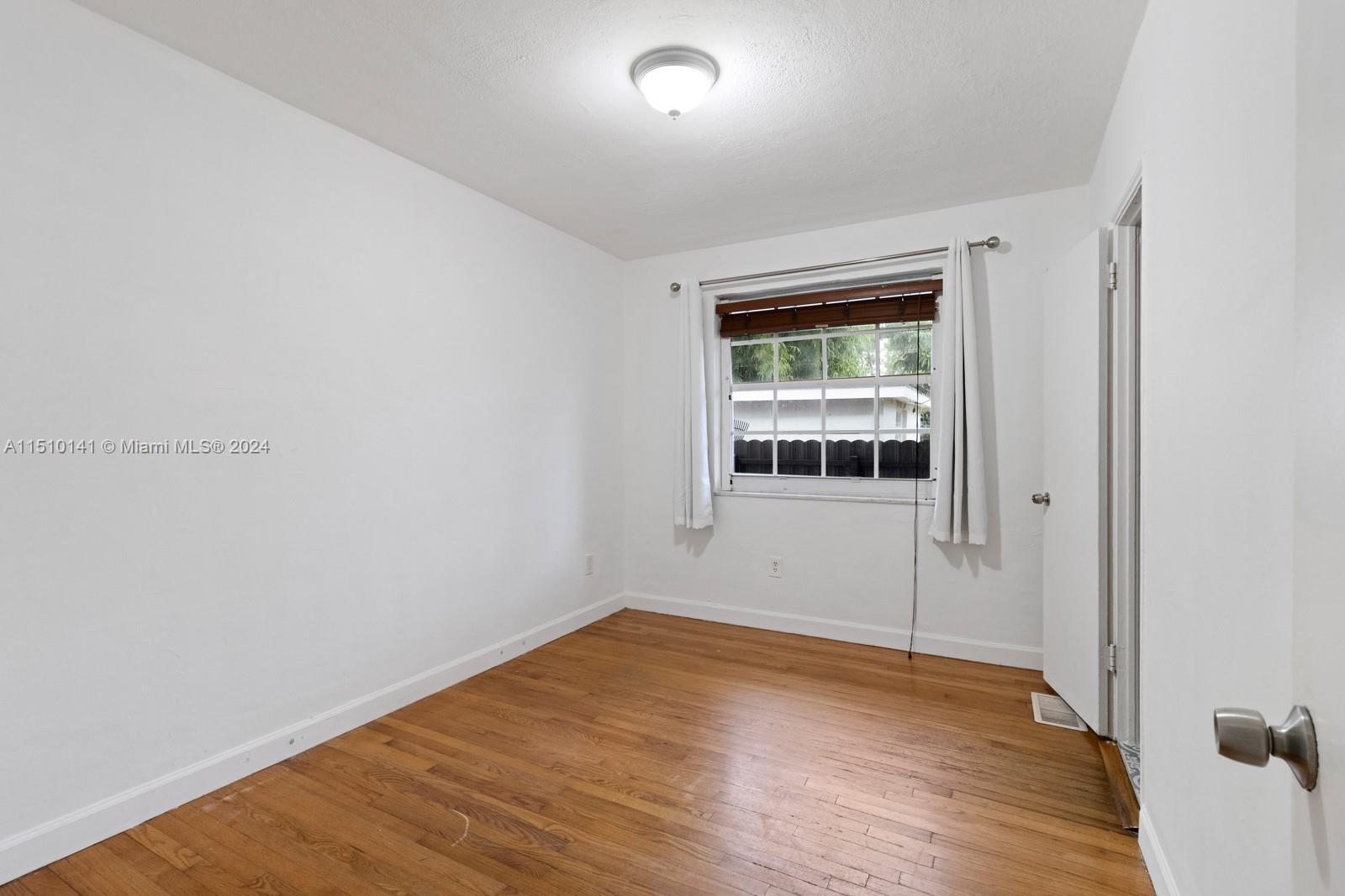 2037 Southwest 22nd Terrace Miami, FL 33145 - Photo 15 of 19 a big room with wooden floor and windows