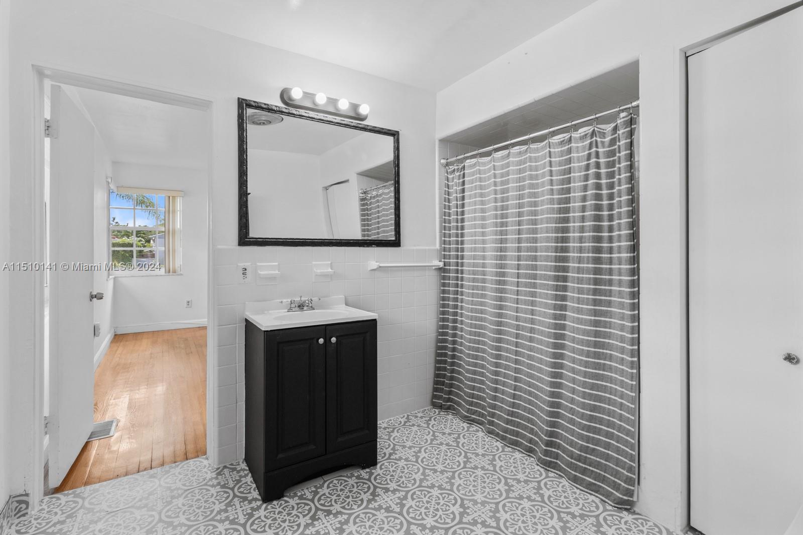 2037 Southwest 22nd Terrace Miami, FL 33145 - Photo 16 of 19 a bathroom with a sink a mirror and bathtub