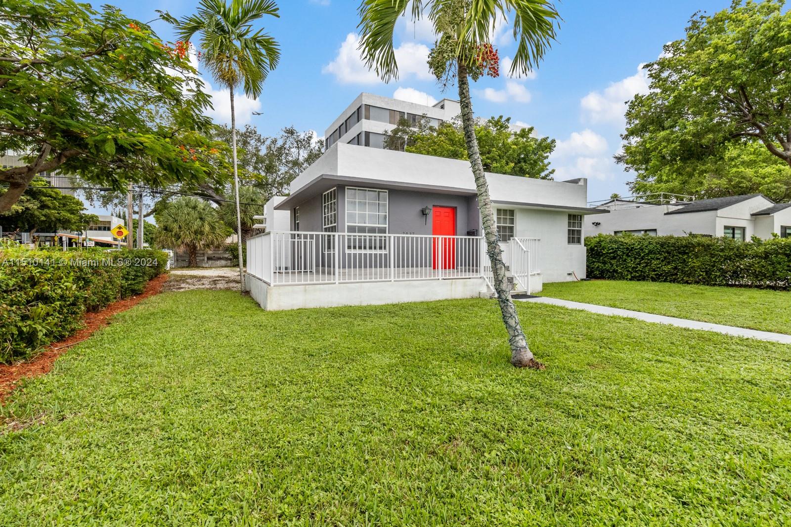 2037 Southwest 22nd Terrace Miami, FL 33145 - Photo 17 of 19 a house with green field in front of it