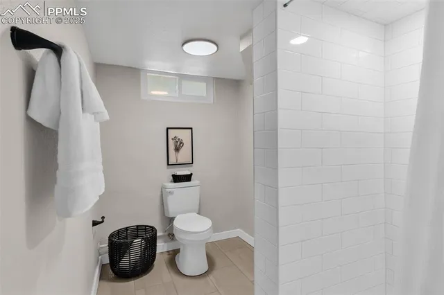 a bathroom with a toilet and a mirror