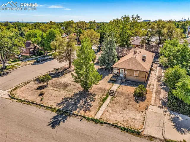 an aerial view of a house with a yard and lake view