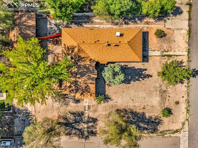 an aerial view of a house with a yard