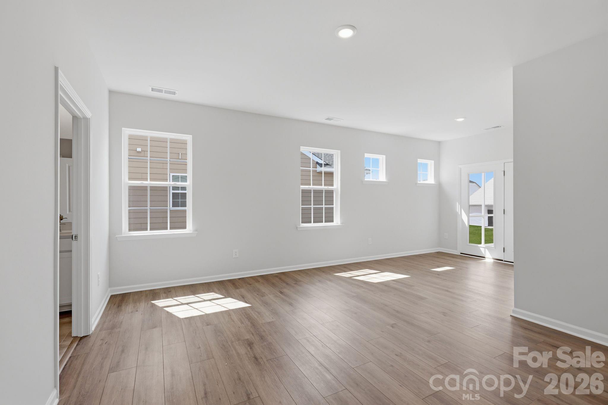 5475 Redbud Road, Unit 57 Lancaster, SC 29720 - Photo 12 of 30 an empty room with wooden floor and windows