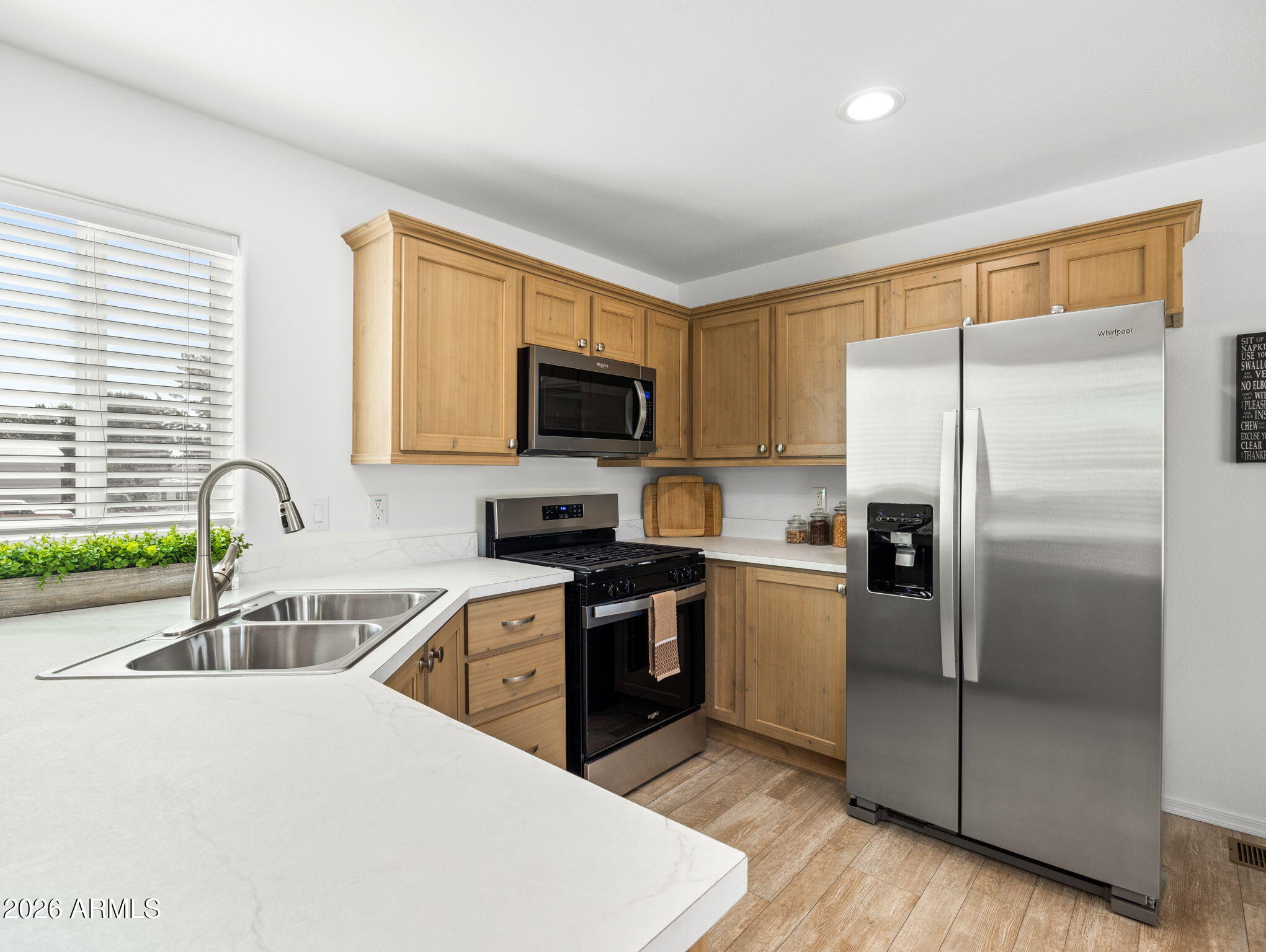 18296 Frontier Road Peeples Valley, AZ 86332 - Photo 12 of 44 a kitchen with a refrigerator sink and stainless steel appliances