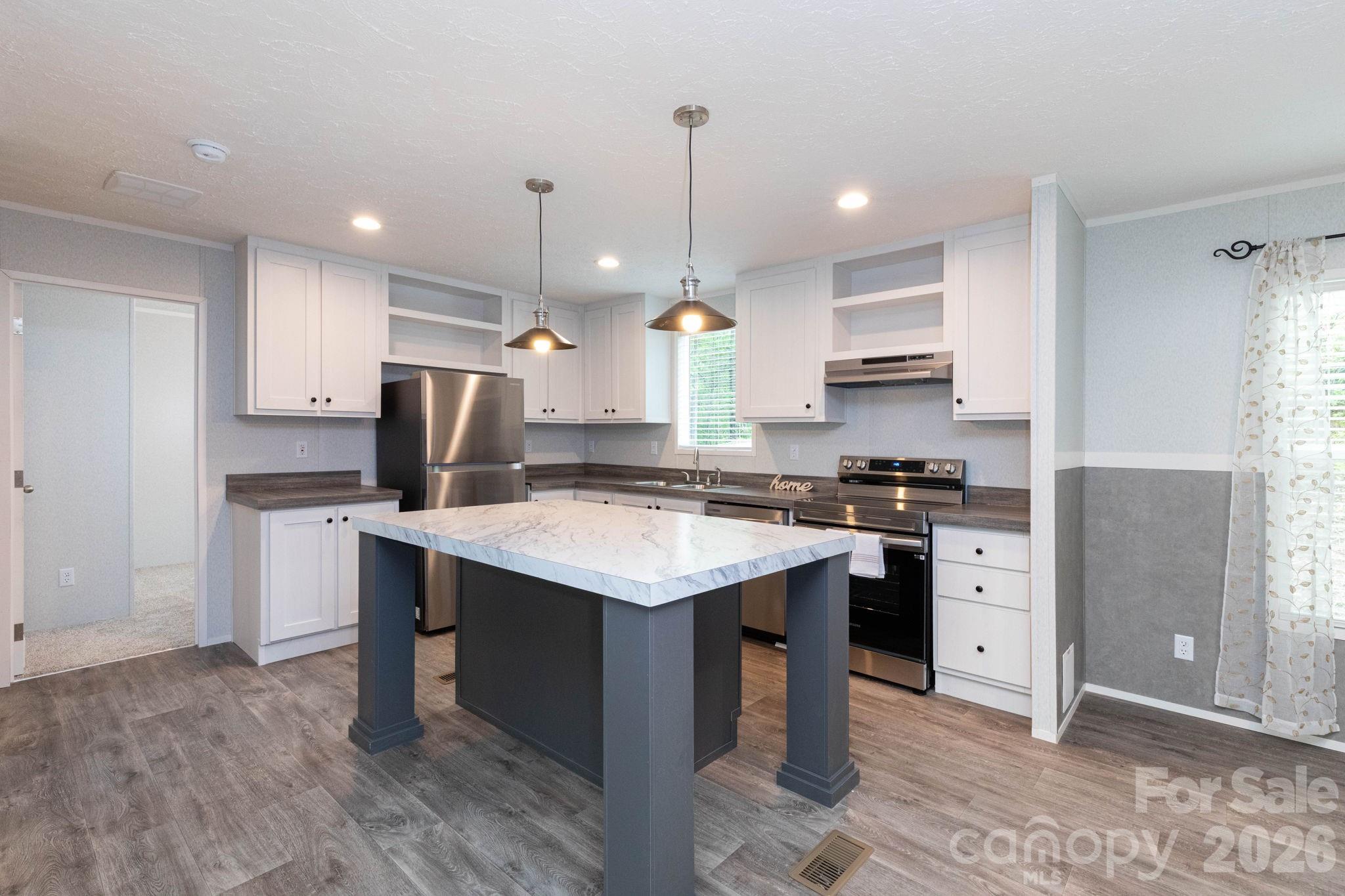 Tbd Kelly Hunter Road Marshall, NC 28753 - Photo 6 of 26 a kitchen with a stove a sink dishwasher a refrigerator and white cabinets with wooden floor