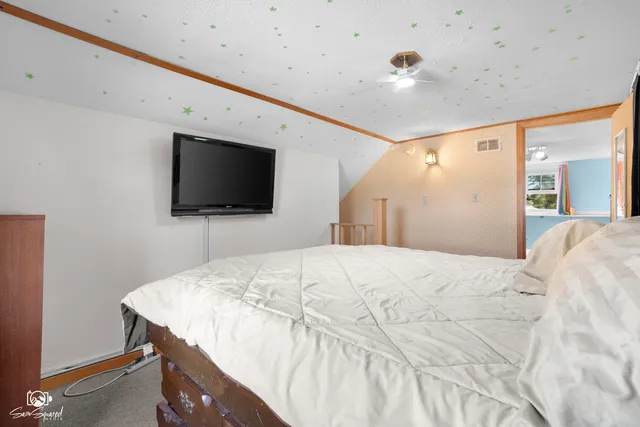 a bedroom with a bed and a flat screen tv