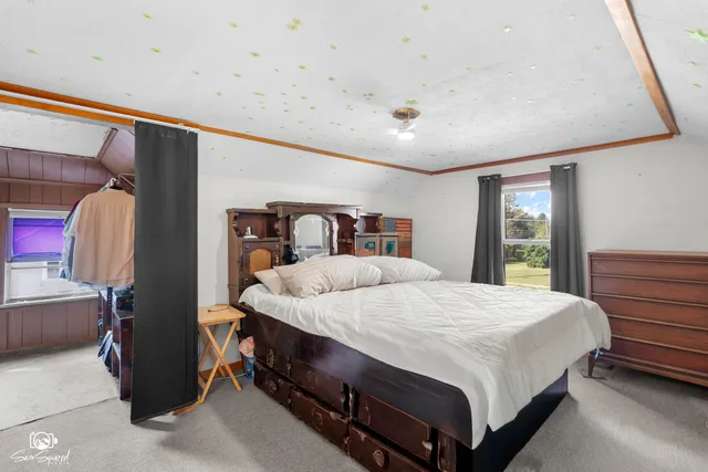 a bedroom with a large bed and a window