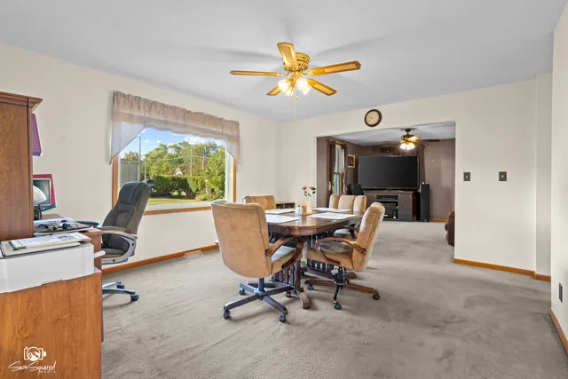 a workspace with wooden floor and a window