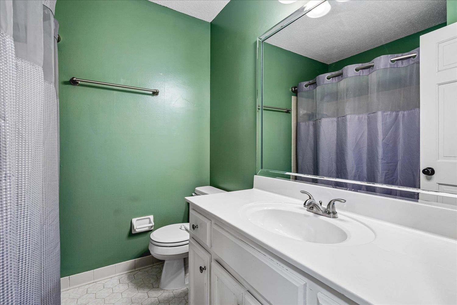 5711 Yale Road Bartlett, TN 38134 - Photo 17 of 29 Bathroom featuring a white vanity with integrated sink, brushed nickel faucet, and a large mirror