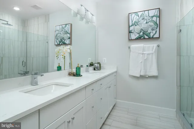 a bathroom with a double vanity sink and a mirror