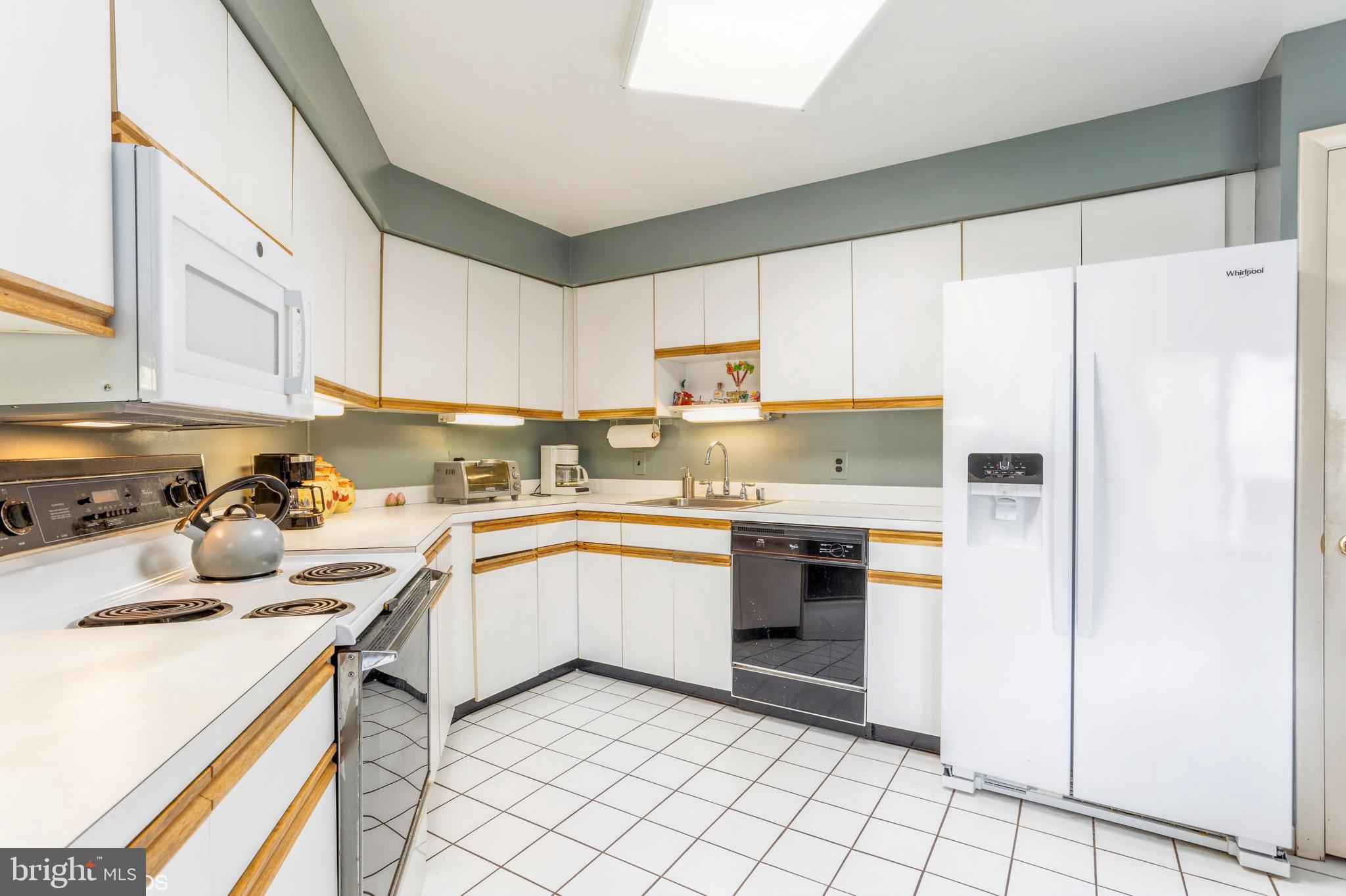 3041 Fallstaff Road, Unit 502D Baltimore, MD 21209 - Photo 18 of 45 a kitchen with a sink a stove and cabinets