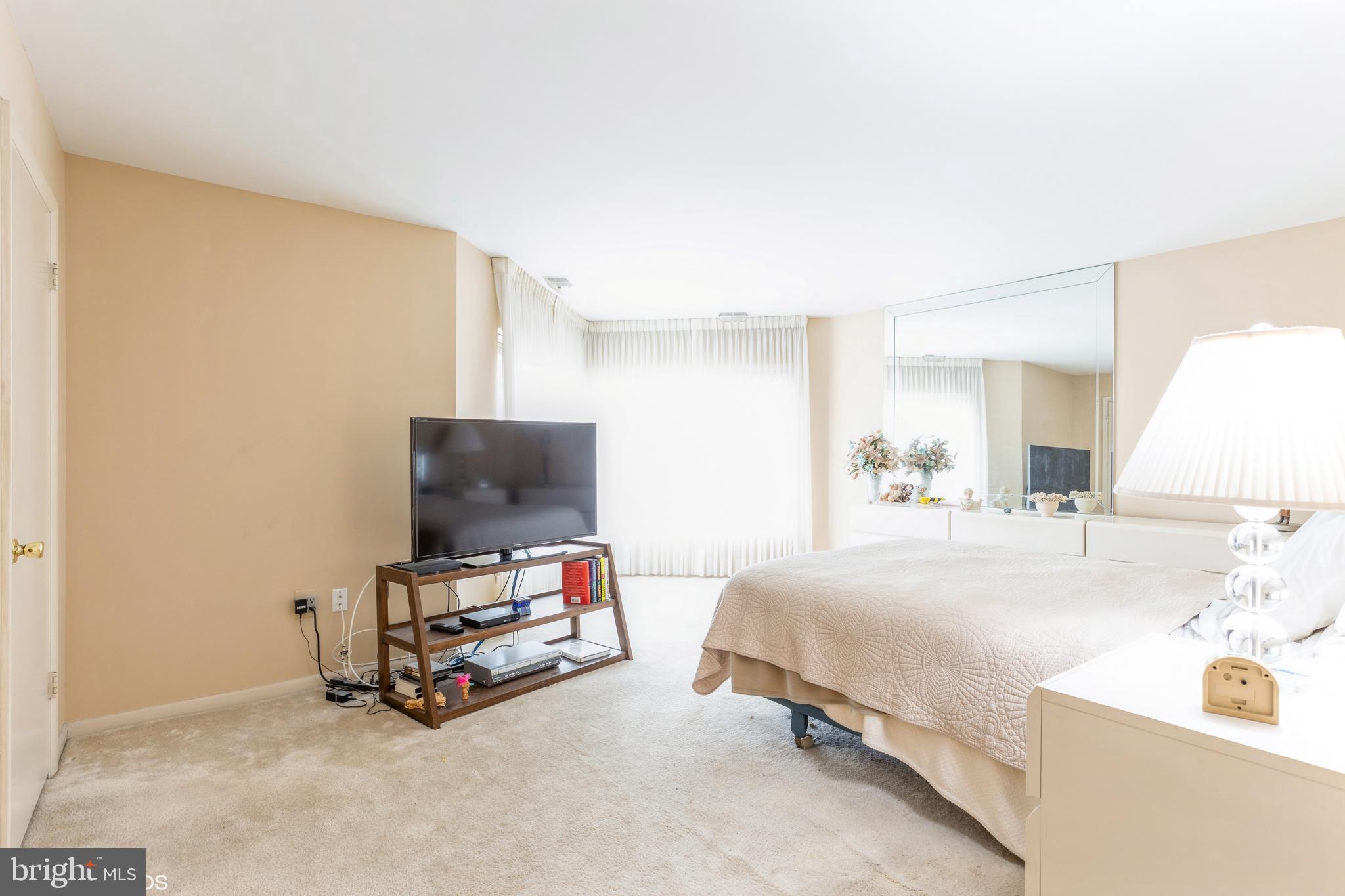 3041 Fallstaff Road, Unit 502D Baltimore, MD 21209 - Photo 28 of 45 a bedroom with a bed and a flat screen tv