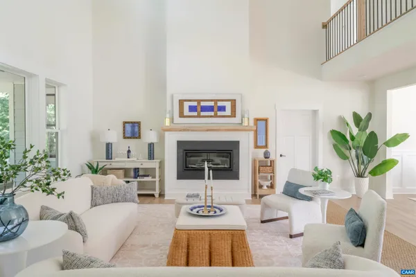 a living room with furniture a fireplace and a large window