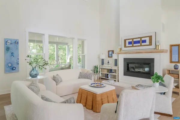a living room with furniture fireplace and a large window