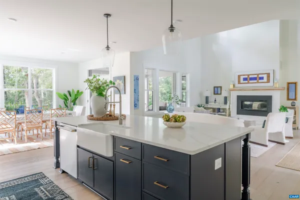 a kitchen with refrigerator and chairs