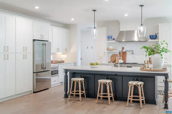 a stove top oven sitting inside of a kitchen