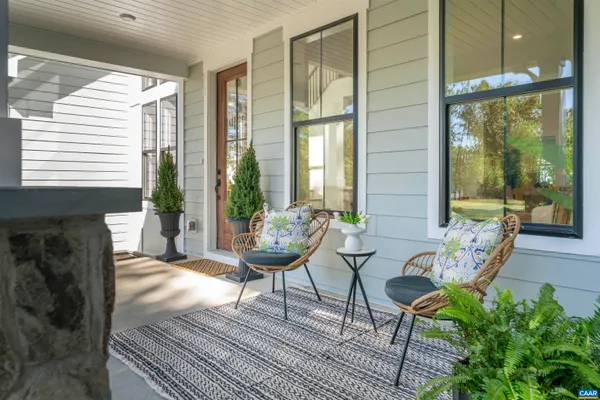 a living room with furniture fireplace and a large window