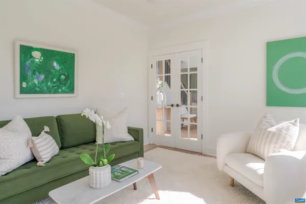 a living room with furniture and a potted plant