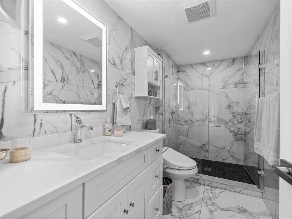 19 Cold Spring Road North Reading, MA 01864 - Photo 19 of 37 a bathroom with a sink a toilet and shower