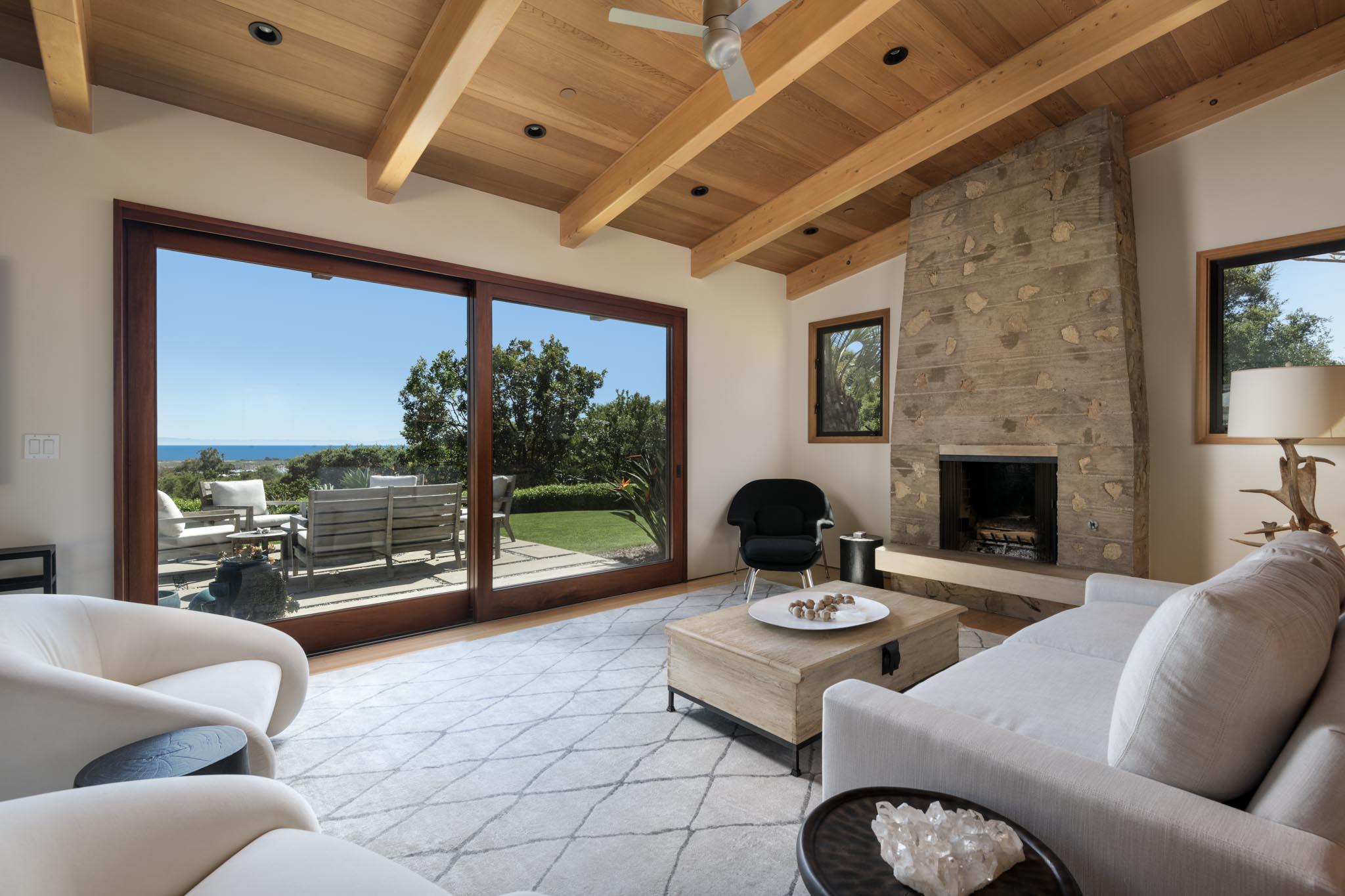 4038 Foothill Road Carpinteria, CA 93013 - Photo 14 of 36 a living room with furniture a fireplace and a flat screen tv