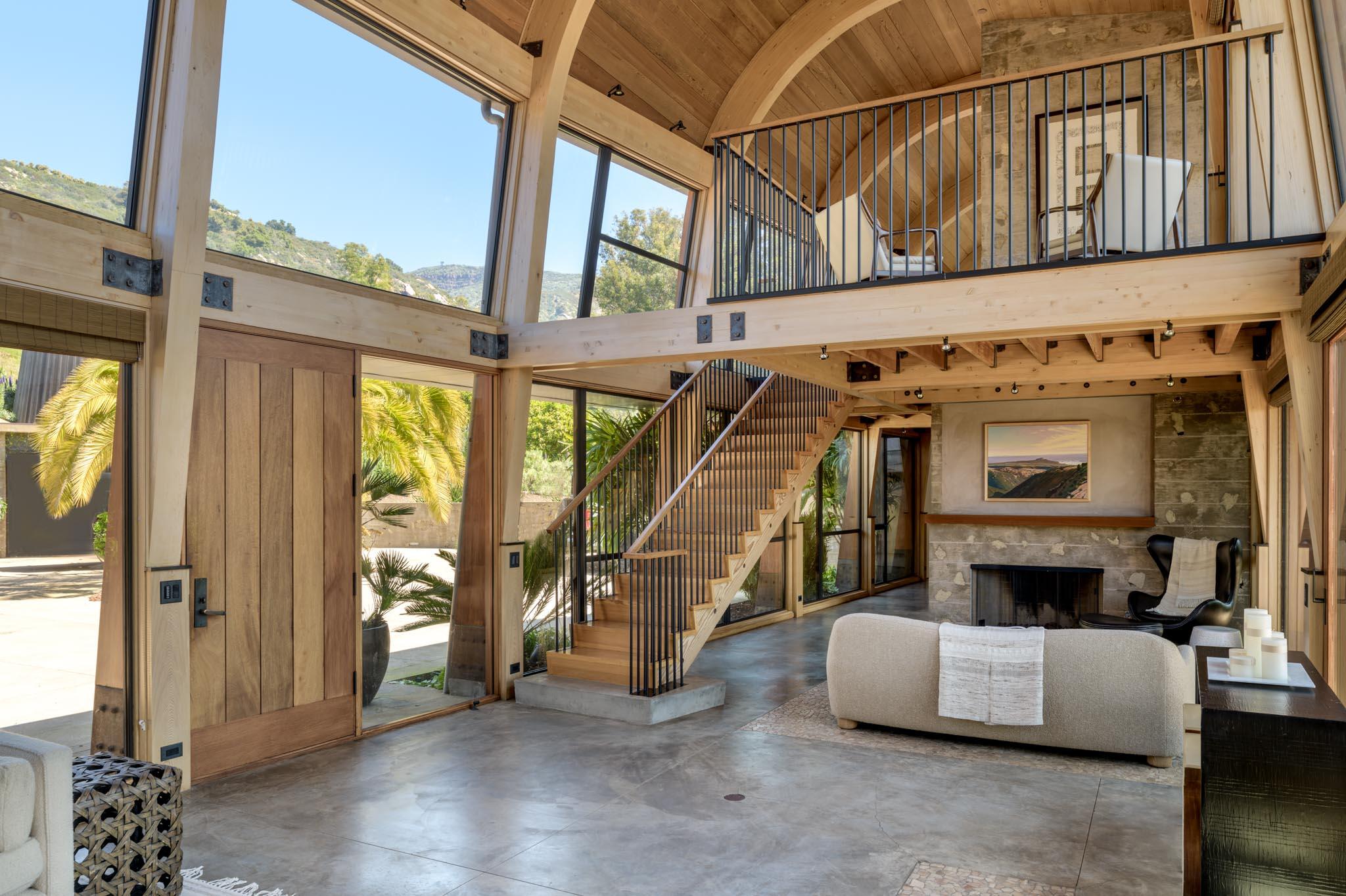 4038 Foothill Road Carpinteria, CA 93013 - Photo 16 of 36 a living room with a couch a fireplace and a large window