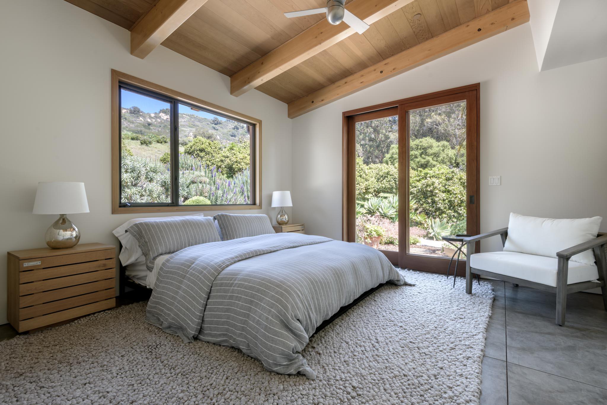 4038 Foothill Road Carpinteria, CA 93013 - Photo 23 of 36 a bedroom with a bed and a large window