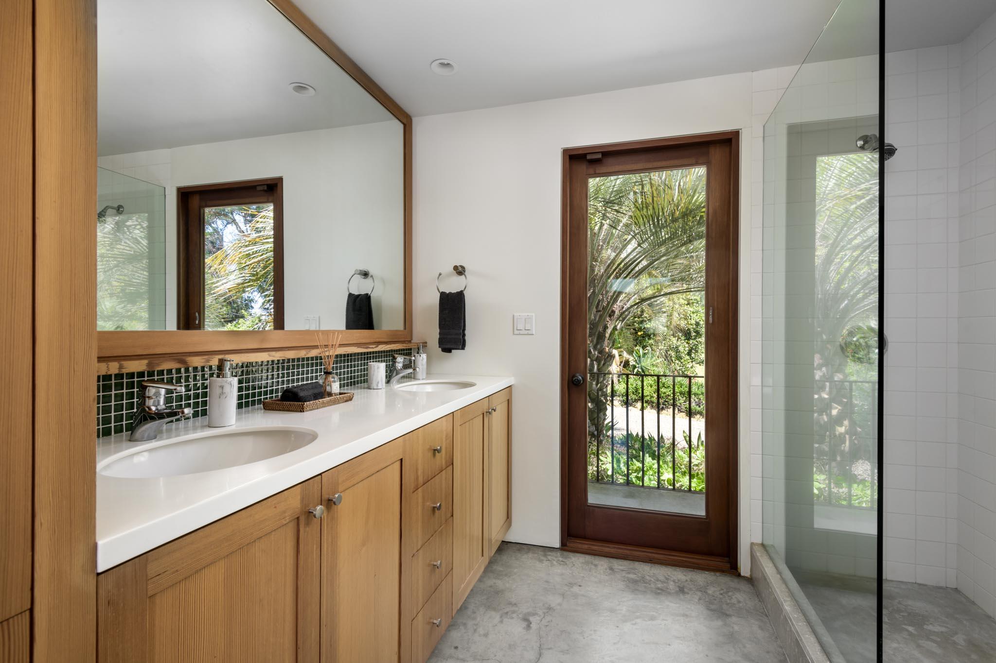 4038 Foothill Road Carpinteria, CA 93013 - Photo 25 of 36 a bathroom with a double vanity sink and a mirror