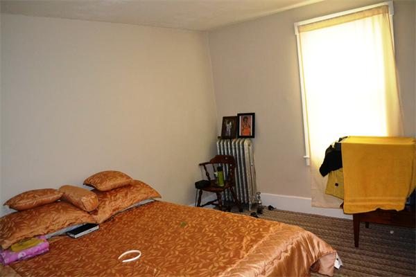 155 Adams Street Waltham, MA 02453 - Photo 4 of 5 a bedroom with a bed and wooden floor
