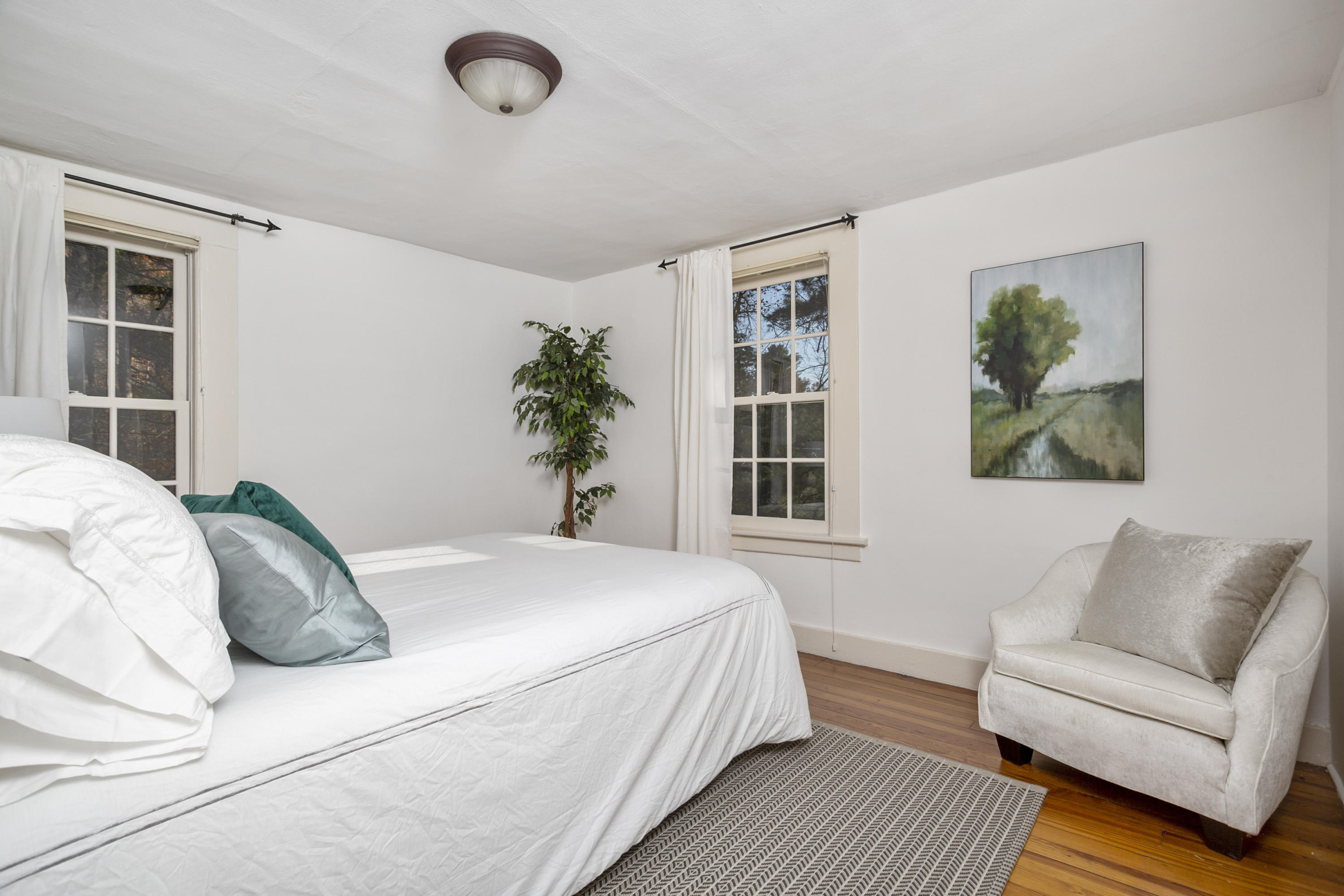 315 Middlesex Road Darien, CT 06820 - Photo 41 of 59 a spacious bedroom with a bed a couch and a window