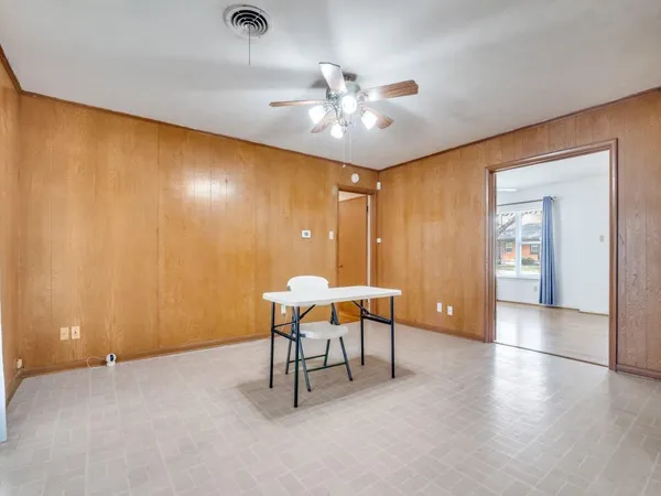 a view of a livingroom with furniture and chandelier fan