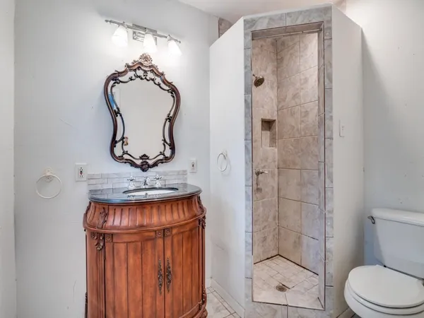 a bathroom with a toilet a sink and shower