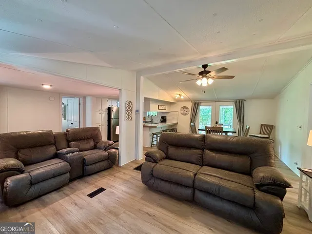 a living room with furniture and a ceiling fan