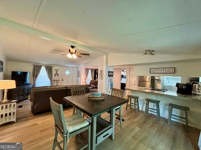 a living room with furniture a table and wooden floor