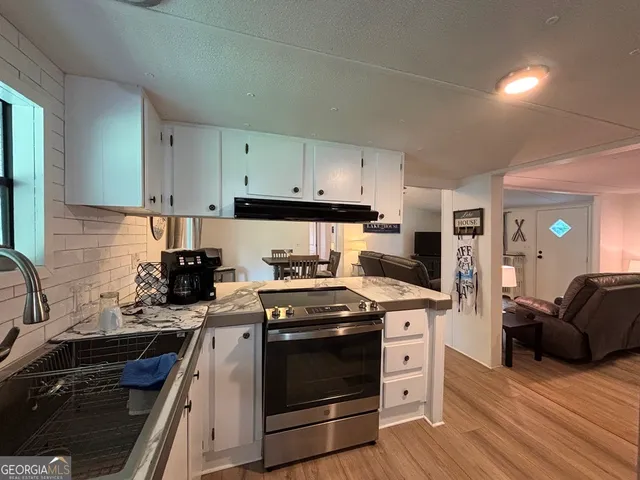 a kitchen with a stove a sink and a refrigerator