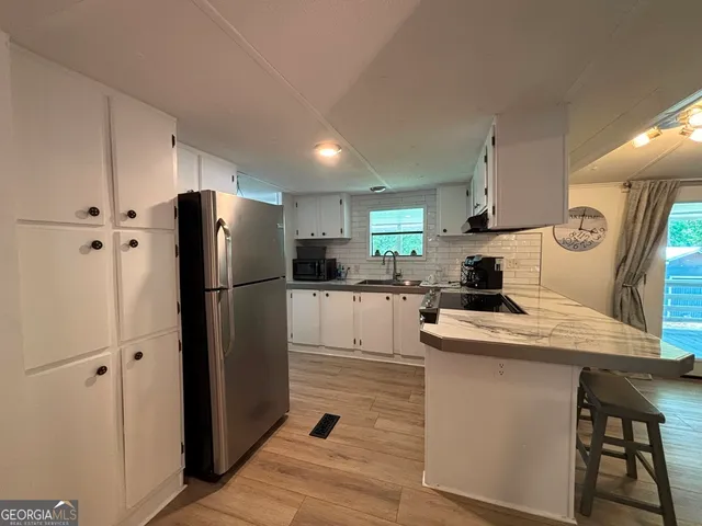 a kitchen with a refrigerator a stove and cabinets