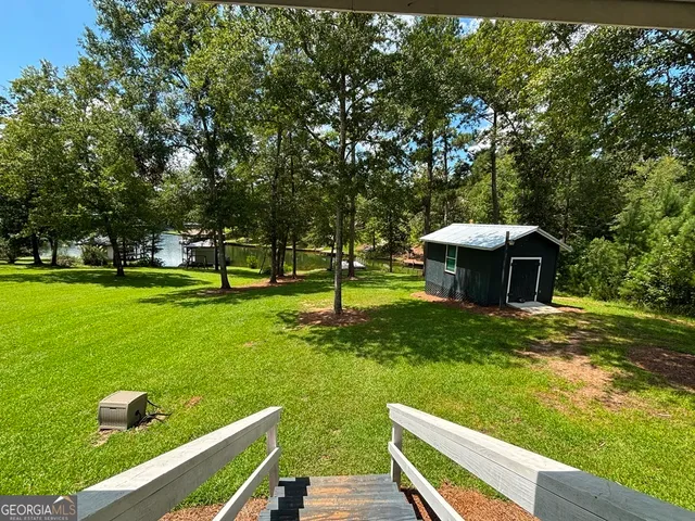 a view of house with backyard