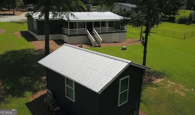 a view of a roof deck with chair and table with swimming pool and sitting area