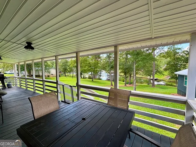 a view of a deck with wooden floor and outdoor seating