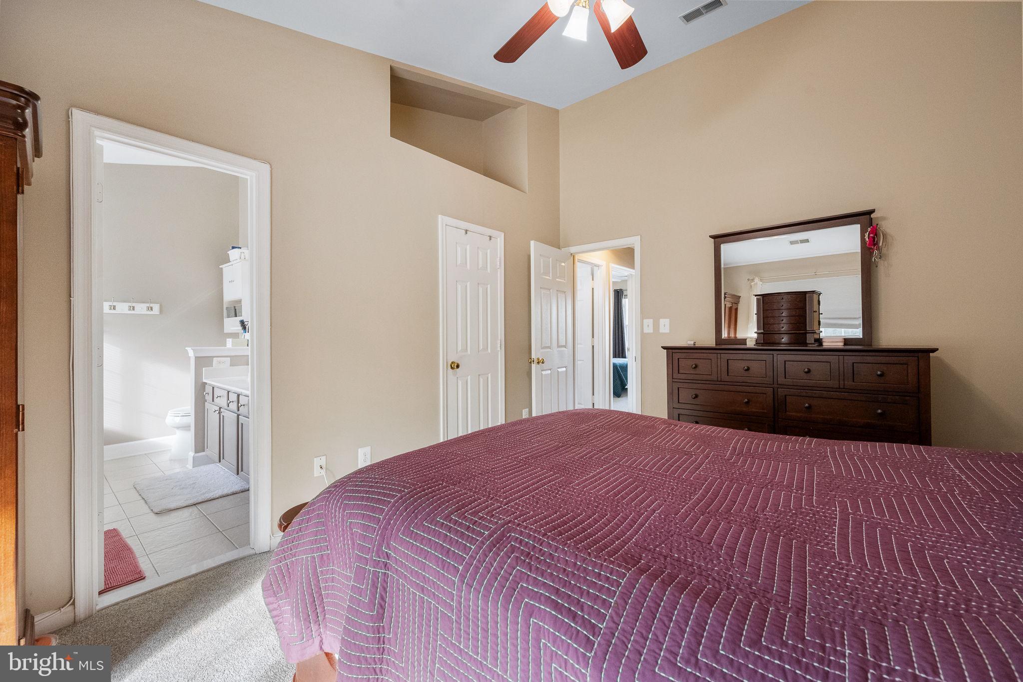 43111 Gatwick Square Ashburn, VA 20147 - Photo 16 of 34 a large bedroom with a bed and a chandelier