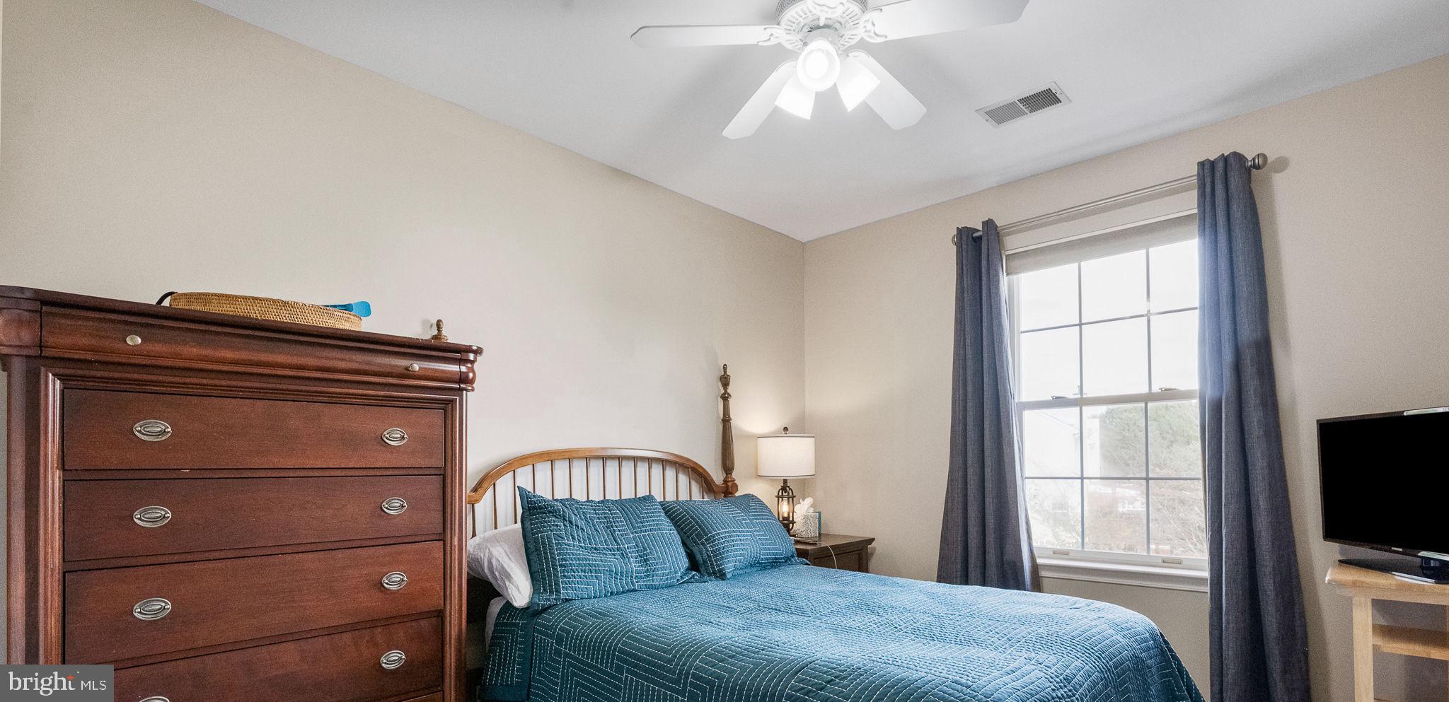 43111 Gatwick Square Ashburn, VA 20147 - Photo 19 of 34 a bedroom with a bed and a flat tv screen on dresser