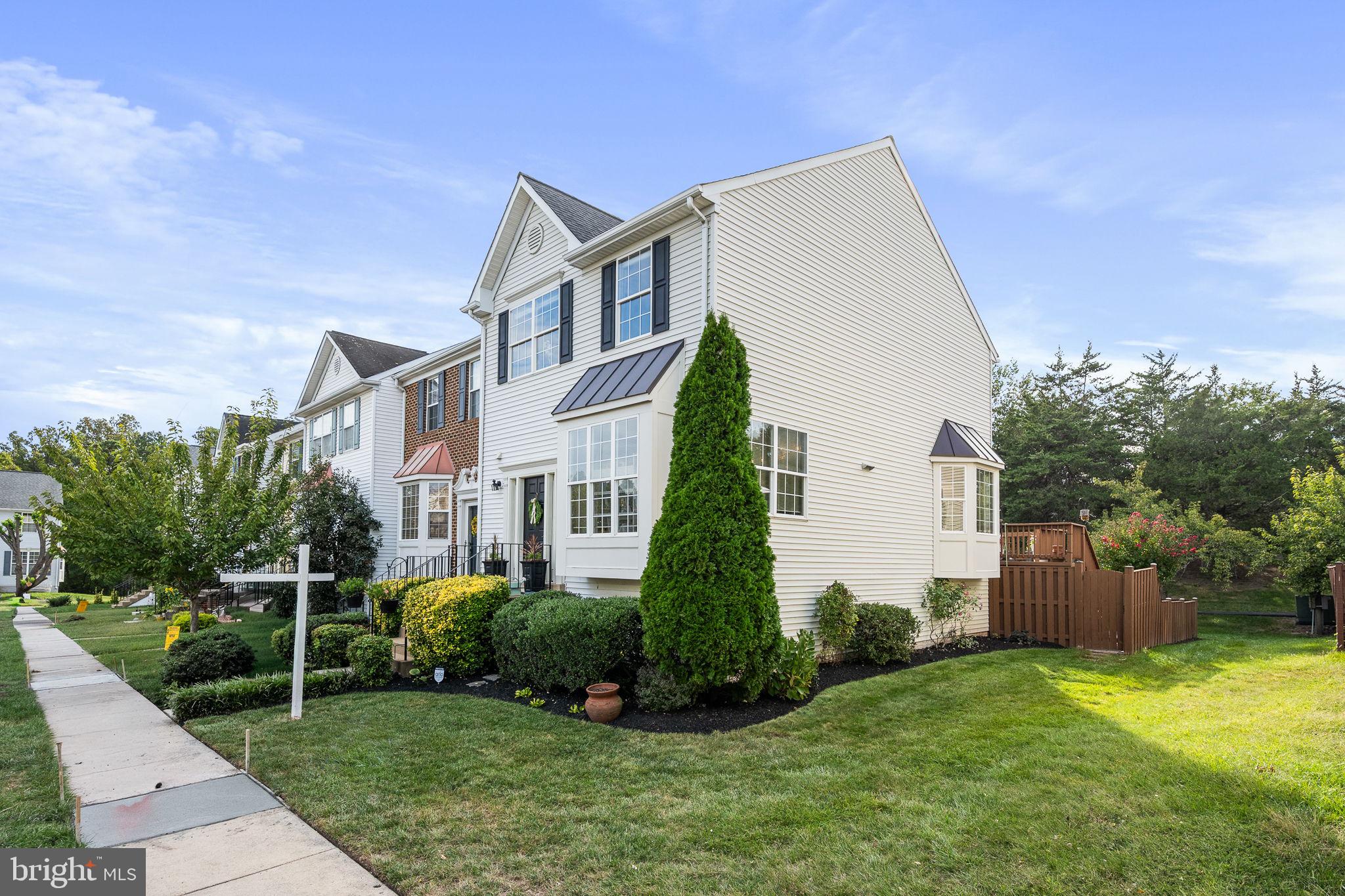 43111 Gatwick Square Ashburn, VA 20147 - Photo 2 of 34 a view of a white house next to a yard with plants and trees