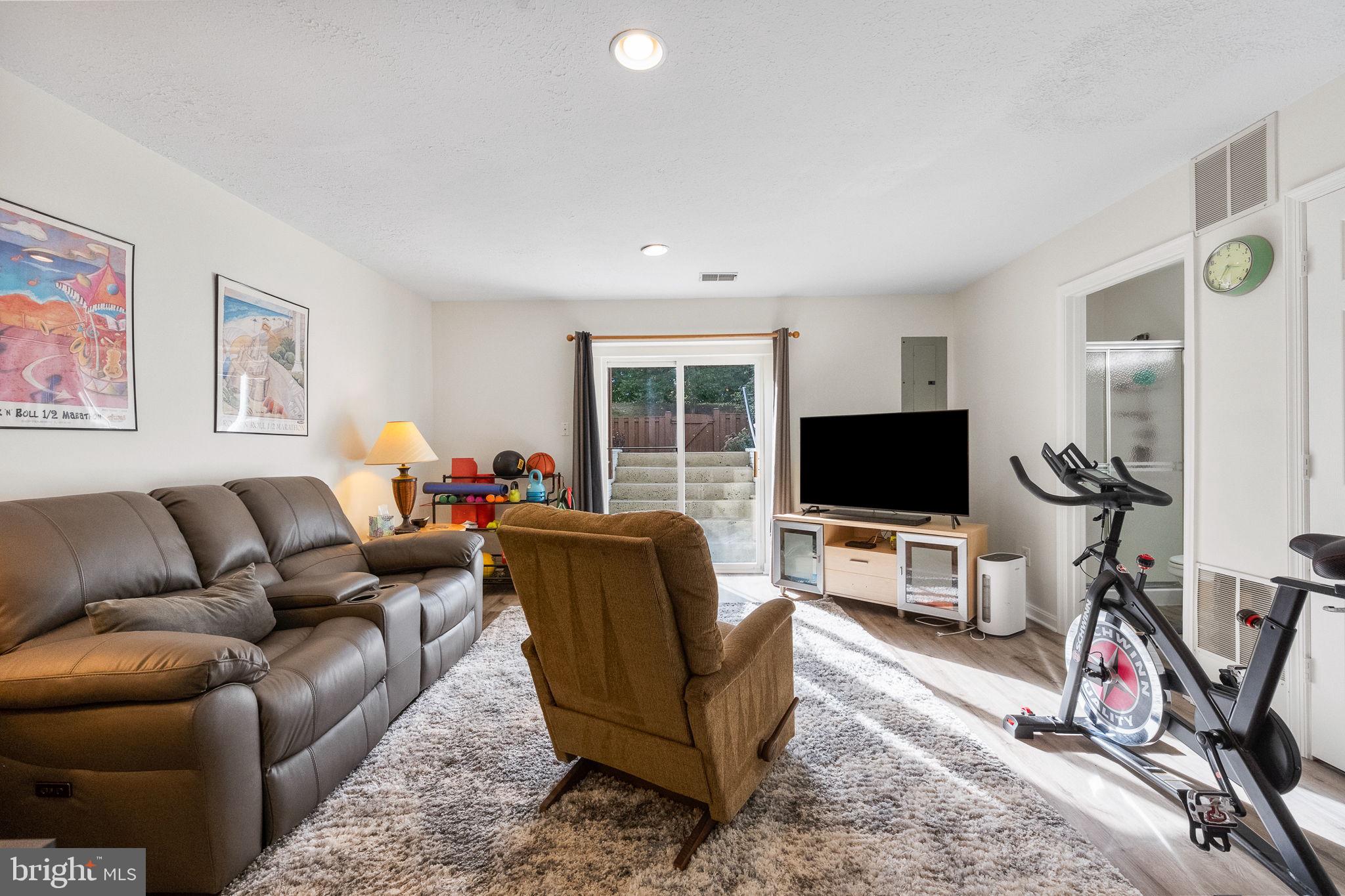 43111 Gatwick Square Ashburn, VA 20147 - Photo 24 of 34 a living room with furniture and a flat screen tv