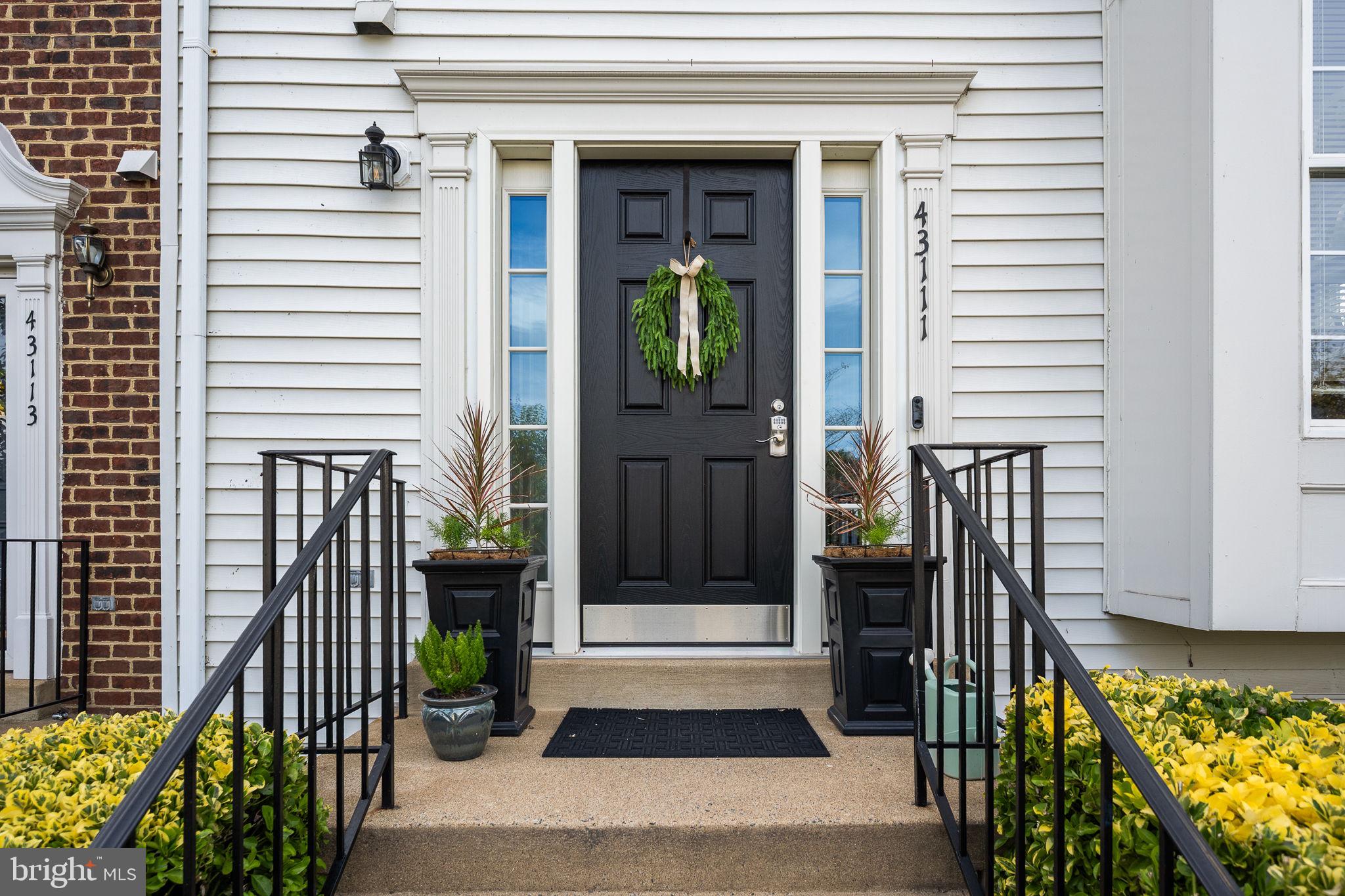 43111 Gatwick Square Ashburn, VA 20147 - Photo 4 of 34 a front view of a house with a porch