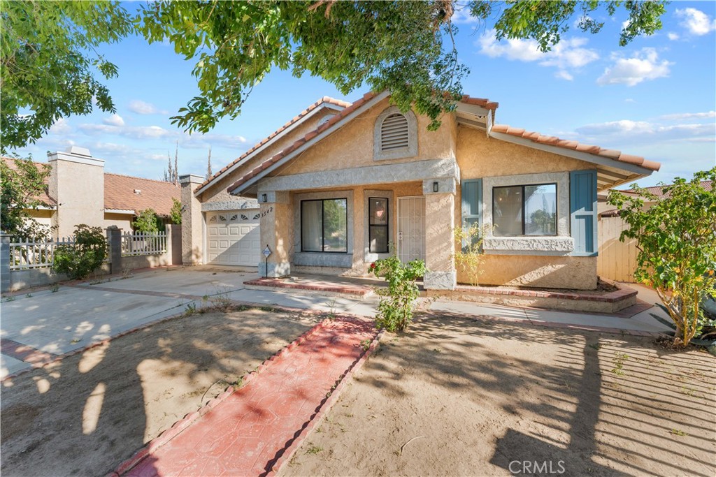 3542 East Ave R 10 Palmdale, CA 93550 - Photo 5 of 35 a front view of a house with yard