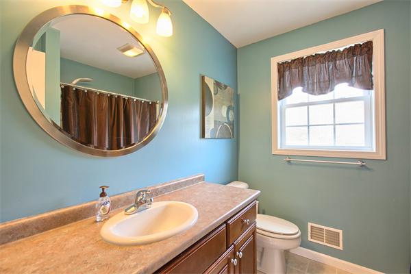92 Scobie Pond Road Derry, NH 03038 - Photo 16 of 30 a bathroom with a sink a mirror and a toilet
