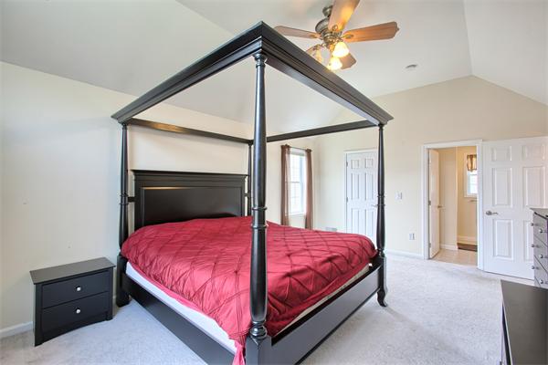 92 Scobie Pond Road Derry, NH 03038 - Photo 24 of 30 a bedroom with a bed and a ceiling fan