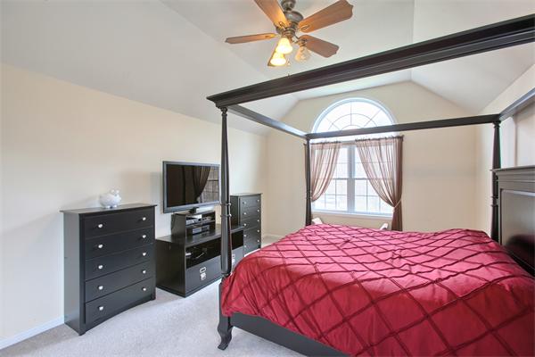 92 Scobie Pond Road Derry, NH 03038 - Photo 25 of 30 a bedroom with a bed and a flat tv screen on dresser